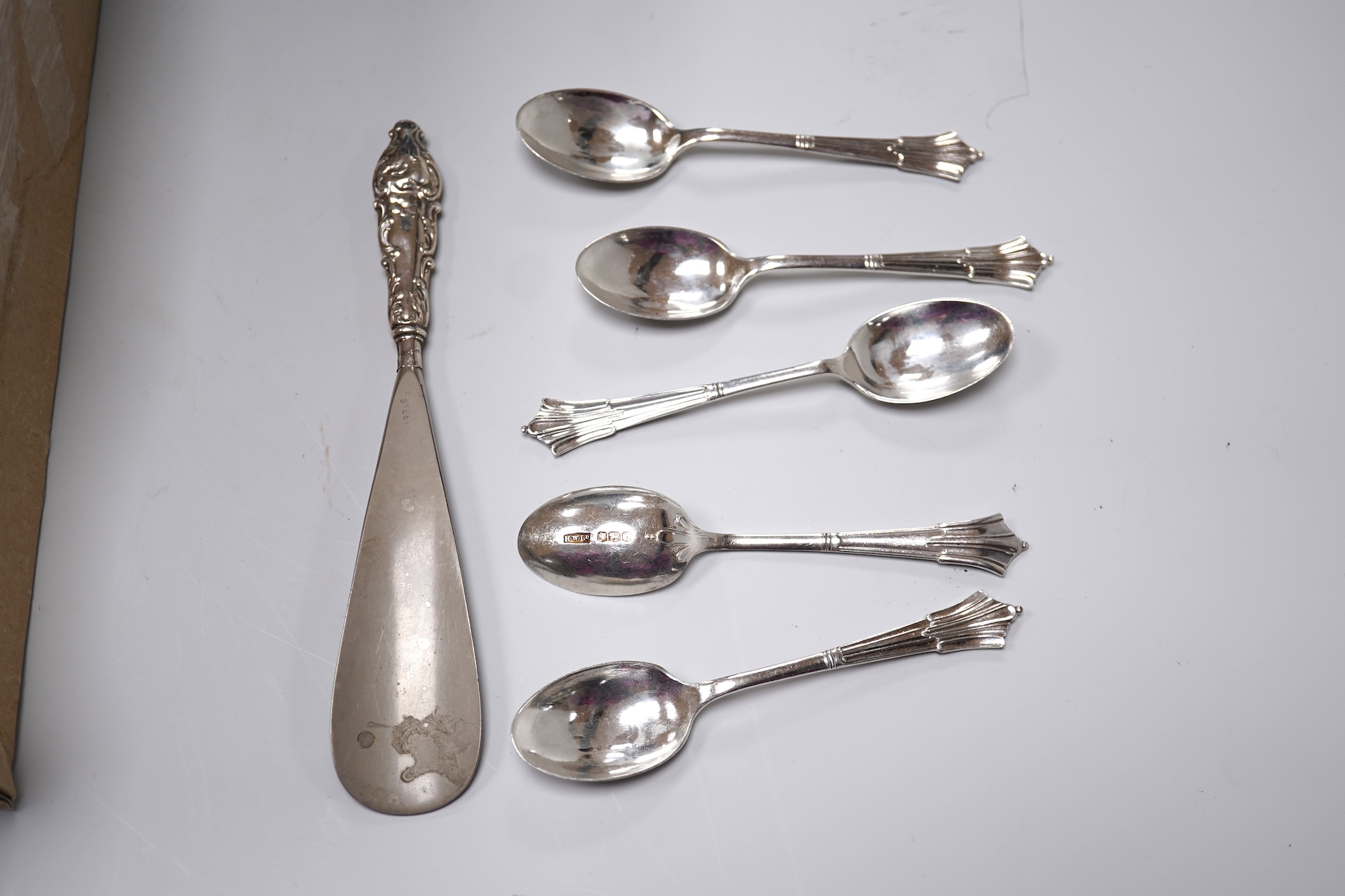 A group of mixed silver including a lidded Wedgwood jug, height 22.5cm (a.f.), mounted hand mirror, two mounted brushes, a mounted capstan inkwell, Edwardian miniature ewer on stand, tortoiseshell pique trinket box, etc.